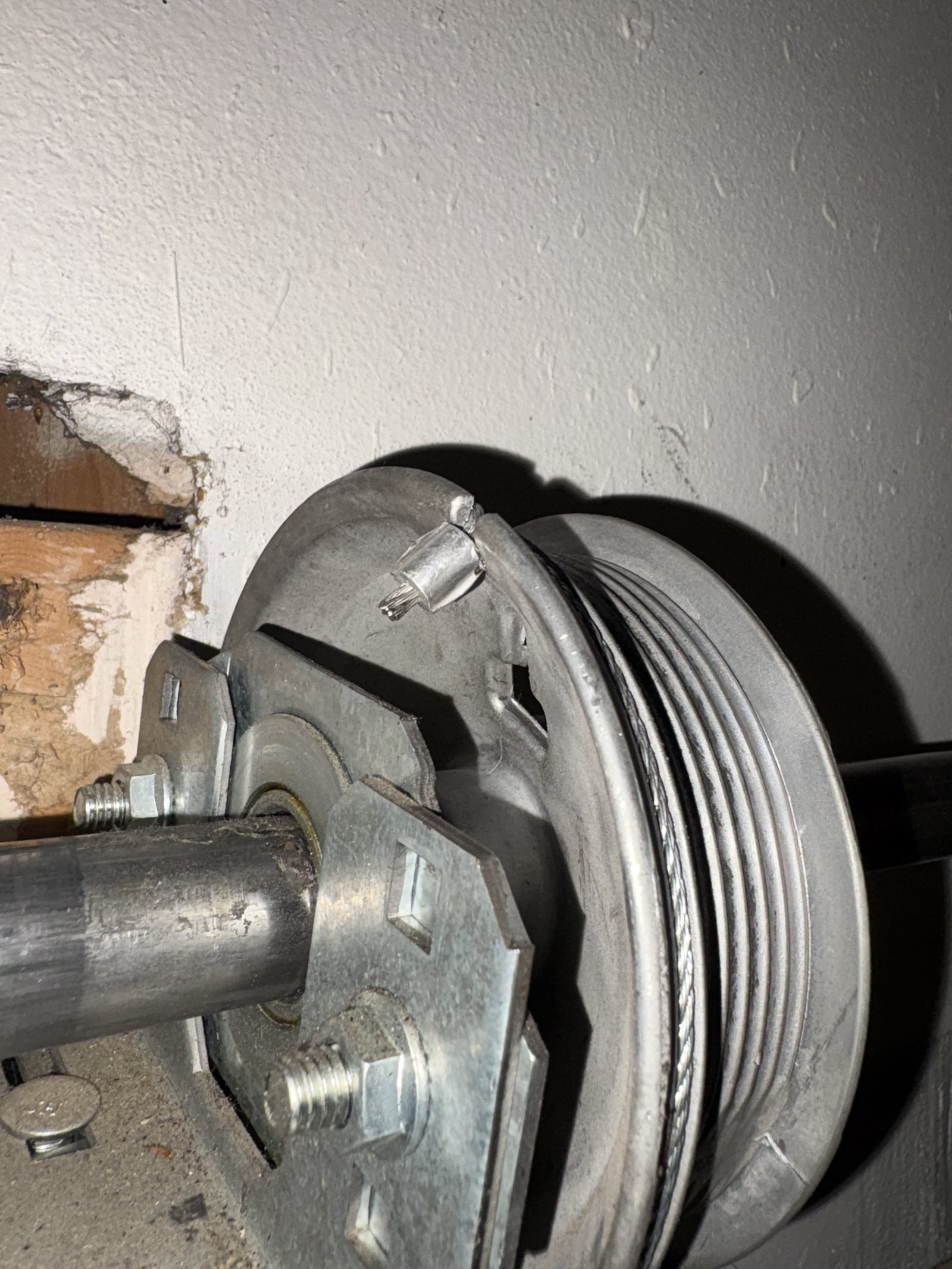 Garage door cable and drum hardware during a repair