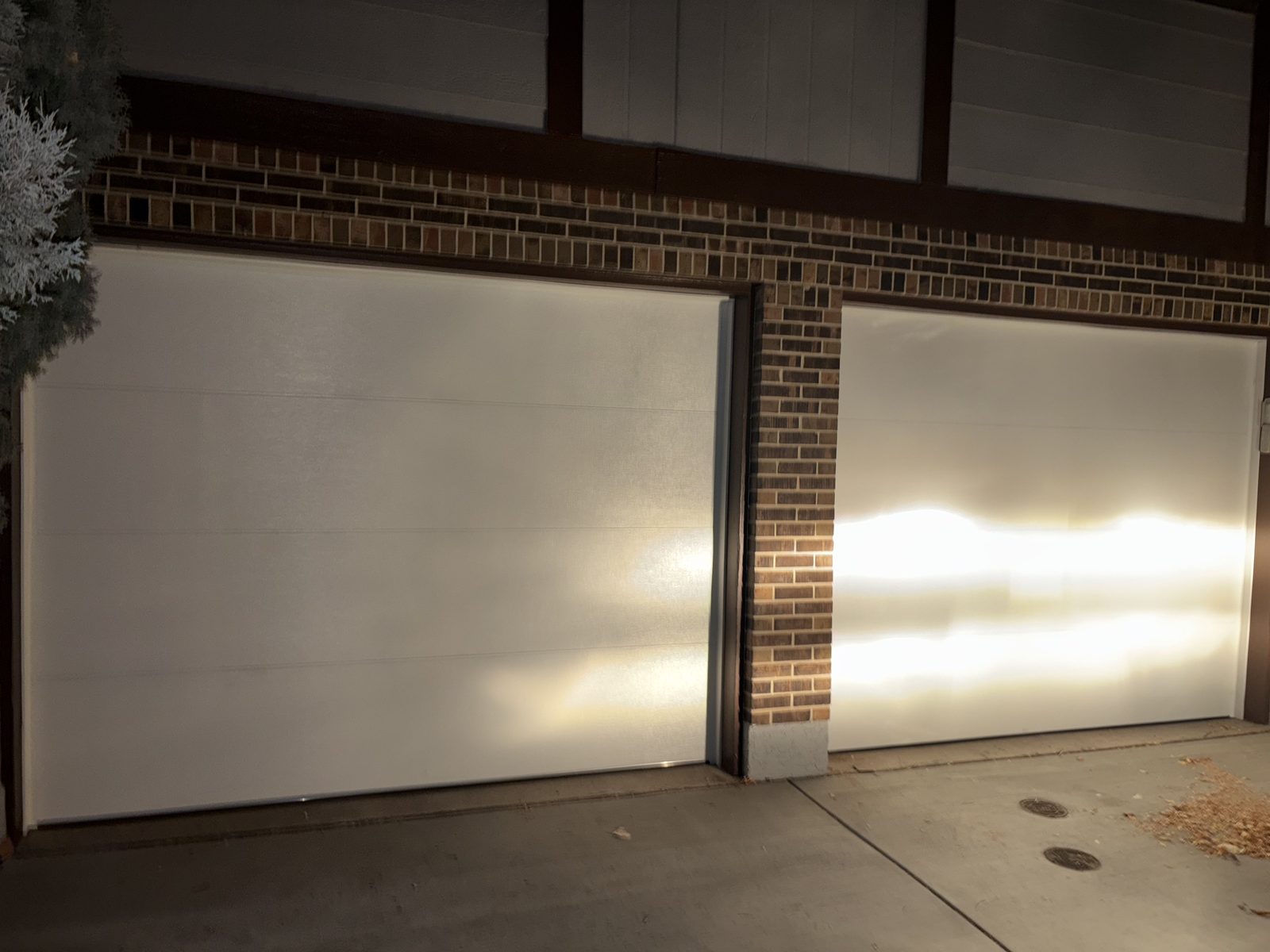 Exterior of a garage door with panel damage being repaired
