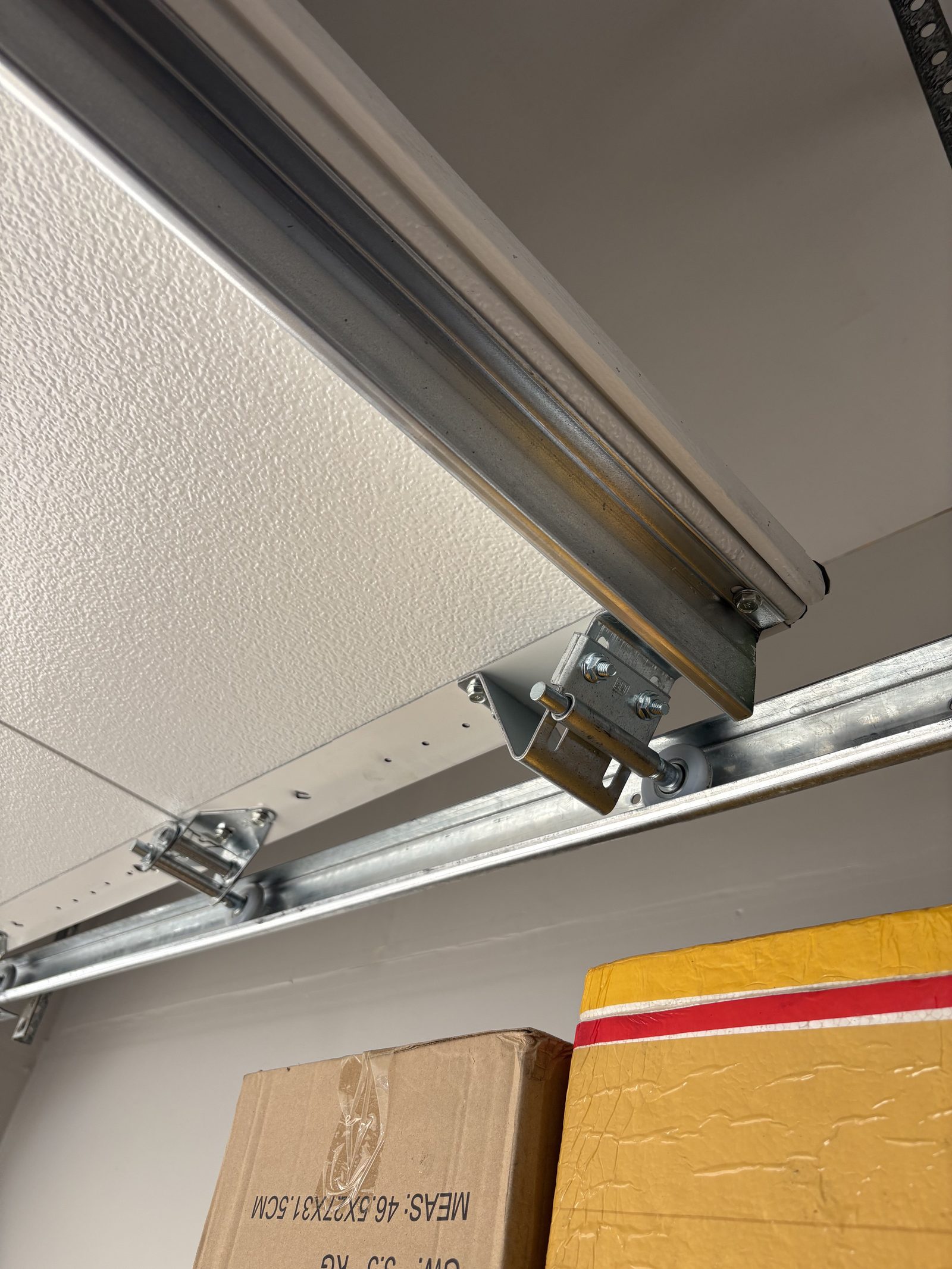 Garage door track and roller maintenance inspection